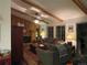 Living room with wood-paneled walls, a fireplace, and a ceiling fan at 12505 N 3Rd St, Parker, CO 80134