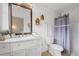 Bright bathroom featuring a vanity with a large mirror, modern fixtures, and stylish decor at 8112 Gray Ct # 394, Arvada, CO 80003