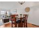 Charming dining area with hardwood floors, a modern light fixture, and comfortable seating at 8112 Gray Ct # 394, Arvada, CO 80003