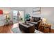 Bright living room features a comfortable sofa, an ottoman, and natural light at 8112 Gray Ct # 394, Arvada, CO 80003