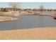 Waterfront pond view with open grassy space, fountains, and walking path at 8112 Gray Ct # 394, Arvada, CO 80003