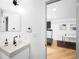 Modern bathroom with vessel sink, bronze faucet, and doorway to gym area at 5401 E Dakota Ave # 3, Denver, CO 80246