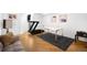 Gym featuring wood floors, a treadmill, a desk, and wall decor at 5401 E Dakota Ave # 3, Denver, CO 80246