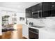 Contemporary kitchen featuring black and white cabinets, stone countertops, and stainless steel appliances at 5401 E Dakota Ave # 3, Denver, CO 80246