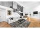 Bright and airy living room featuring a large sofa, modern decor, and hardwood floors, with a view of the dining area at 5401 E Dakota Ave # 3, Denver, CO 80246