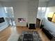 Sunlit living room with a modern fireplace, wood floors, and large windows offering scenic views at 5401 E Dakota Ave # 3, Denver, CO 80246