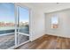 Balcony with sliding glass doors and wooden floors overlooking a vibrant neighborhood at 3430 W 25Th Ave, Denver, CO 80211