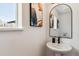 Modern powder room with stylish mirror, pedestal sink, and white walls at 3430 W 25Th Ave, Denver, CO 80211