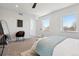 Bright bedroom featuring a ceiling fan, two windows, and neutral-colored walls and carpet at 3430 W 25Th Ave, Denver, CO 80211