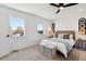 Comfortable bedroom with carpet, stylish ceiling fan, and natural light from large windows at 3430 W 25Th Ave, Denver, CO 80211