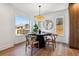 Dining area featuring stylish lighting, hardwood floors, and a view to the exterior at 3430 W 25Th Ave, Denver, CO 80211