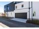 Modern home featuring sleek design with a black garage door, siding, and complementing black accents at 3430 W 25Th Ave, Denver, CO 80211