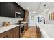 Modern kitchen featuring stainless steel appliances and sleek black and wood cabinets at 3430 W 25Th Ave, Denver, CO 80211