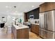 Open kitchen with a center island, stainless steel appliances, and wood cabinetry at 3430 W 25Th Ave, Denver, CO 80211