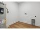 Laundry room with wooden vinyl flooring, white walls, hookups and a water heater at 3430 W 25Th Ave, Denver, CO 80211