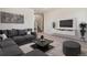 Cozy living room with comfortable seating, modern entertainment center, and soft carpet at 3430 W 25Th Ave, Denver, CO 80211