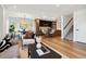 Spacious open-concept living and dining area with modern kitchen and staircase at 3430 W 25Th Ave, Denver, CO 80211