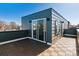 Exterior view of a rooftop deck with a sliding glass door and patterned wood tiles at 3430 W 25Th Ave, Denver, CO 80211