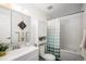 Clean bathroom featuring a large vanity, shower with bathtub and modern fixtures at 64 Nome Way # A, Aurora, CO 80012