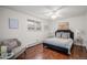 Comfortable bedroom featuring wood floors, ceiling fan, and a queen bed with stylish decor at 64 Nome Way # A, Aurora, CO 80012