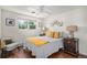 Cozy bedroom with wood floors and featuring a queen bed and two side tables at 64 Nome Way # A, Aurora, CO 80012