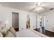 Bright bedroom with wood floors, ceiling fan, a view to an ensuite, and multiple closets at 64 Nome Way # A, Aurora, CO 80012