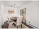Dining room with a modern light fixture and sliding door at 64 Nome Way # A, Aurora, CO 80012