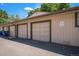 Multiple garages in a community featuring beige siding and a paved parking lot at 64 Nome Way # A, Aurora, CO 80012