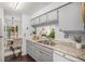 Kitchen with gray cabinets, granite countertops, and a view into the dining room at 64 Nome Way # A, Aurora, CO 80012