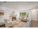 Bright living room with fireplace, large windows, hardwood floors, and stylish decor at 64 Nome Way # A, Aurora, CO 80012