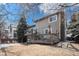 Backyard exterior featuring mature trees and a two-level wooden deck at 9314 Wiltshire Dr, Highlands Ranch, CO 80130