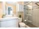 Bright bathroom featuring a modern vanity, toilet, and a beautifully tiled walk-in shower with glass doors at 9314 Wiltshire Dr, Highlands Ranch, CO 80130