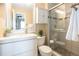 Bright bathroom featuring a modern vanity, toilet, and a beautifully tiled walk-in shower with glass doors at 9314 Wiltshire Dr, Highlands Ranch, CO 80130