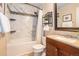 Bright bathroom featuring marble tile, updated vanity, bathtub, and modern fixtures at 9314 Wiltshire Dr, Highlands Ranch, CO 80130