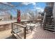 Outdoor deck featuring wood railings, dining table, and seating area at 9314 Wiltshire Dr, Highlands Ranch, CO 80130