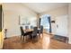 Open concept dining area features a large window, high ceilings, and hardwood floors at 9314 Wiltshire Dr, Highlands Ranch, CO 80130