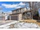 Charming two-story home with brick accents, attached two car garage, and landscaped front yard at 9314 Wiltshire Dr, Highlands Ranch, CO 80130