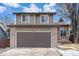 This is the front facade of the home and its attached two car garage at 9314 Wiltshire Dr, Highlands Ranch, CO 80130