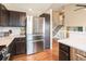 Kitchen featuring stainless steel appliances, stone countertops, subway tile, and hardwood floors at 9314 Wiltshire Dr, Highlands Ranch, CO 80130