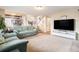 Inviting living room featuring a comfortable sofa, neutral walls, and an open floor plan leading to the staircase at 9314 Wiltshire Dr, Highlands Ranch, CO 80130