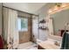 Bathroom with shower-tub combo, decorative tile, and stylish fixtures at 9146 W 89Th Ct, Broomfield, CO 80021
