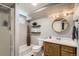Renovated bathroom with modern vanity, updated fixtures, and decorative shelving for storage at 9146 W 89Th Ct, Broomfield, CO 80021