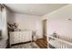 Bright Bedroom with hardwood floors, changing table, and cozy crib at 9146 W 89Th Ct, Broomfield, CO 80021