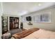 Spacious bedroom featuring a mounted TV and an organized open closet at 9146 W 89Th Ct, Broomfield, CO 80021