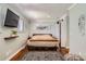 Well-lit bedroom with hardwood floors, modern art, and a cozy rug at 9146 W 89Th Ct, Broomfield, CO 80021