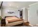 Bright bedroom with hardwood floors, large painting, and walk-in closet at 9146 W 89Th Ct, Broomfield, CO 80021