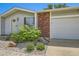 Close-up of the home's exterior, featuring a brick facade, garage, and landscaped front yard at 9146 W 89Th Ct, Broomfield, CO 80021