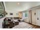 Inviting living room with a sectional couch, hardwood floors, and view of the front yard at 9146 W 89Th Ct, Broomfield, CO 80021