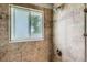 Close-up of shower with tiled walls and natural light from the window at 9146 W 89Th Ct, Broomfield, CO 80021