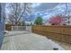 Spacious backyard deck with white railing and a wood fence, ideal for outdoor entertaining and relaxation at 16780 E Hialeah Ave, Centennial, CO 80015